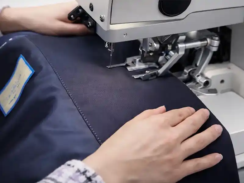 Advanced production infrastructure featuring pick stitch, bartack, and automated welt pocket machines.