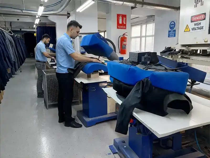 Specialized final pressing and steaming systems for professional jacket form-finishing.